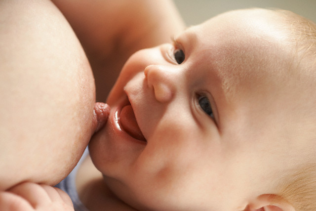 Baby breastfeeding --- Image by © Heide Benser/Corbis